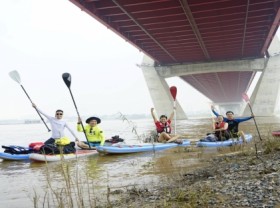 Image: Young people in Hanoi try paddle boarding on Red river