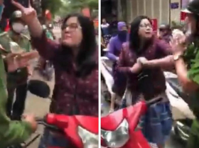 Image: In Vietnam, female traffic rule violator insults and hits police officers for booking her