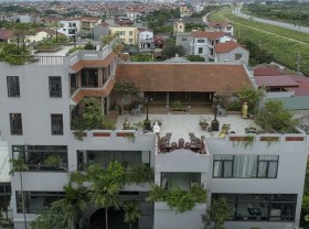 Image: The family cranes a 100-year-old house to the roof of the villa