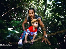 Image: A 22-month-old boy with his father trekking in Cat Ba forest