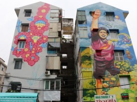 Image: Colourful murals cover old buildings in HCM City
