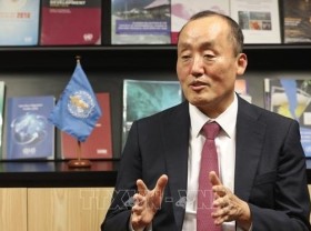 Image: WHO representative honoured with insignia