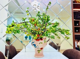 Image: Hanoians play with plum branches