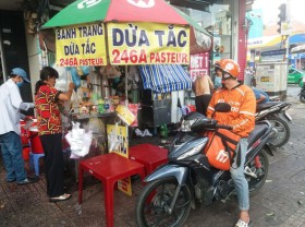 Image: Cooling down on coconut water street in downtown Ho Chi Minh City