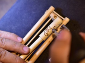 Image: Vietnamese man makes incredible woodburning art on bamboo pens