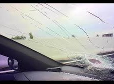 Image: Large Rock Falls from Overpass, Shattering Car Window on Highway