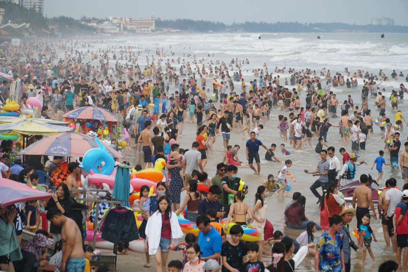 Waves of tourists lap at Vung Tau beach for a New Year dip