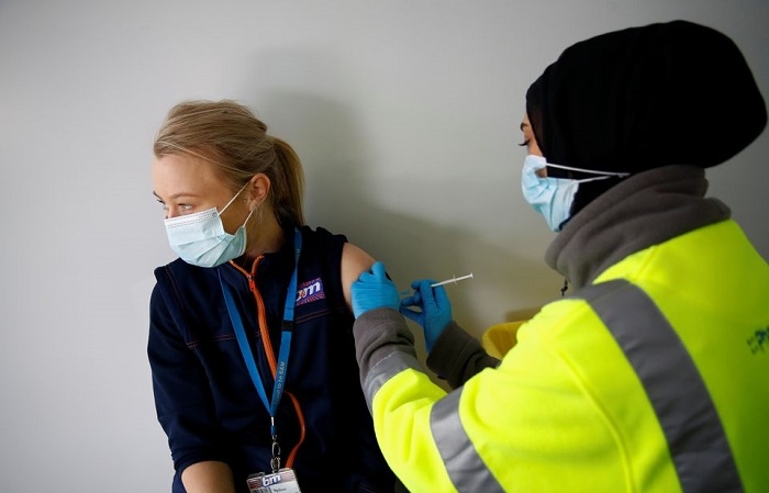 Britain allows early booking of booster shots to speed up rollout
