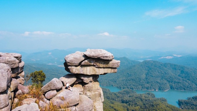 The stacked stone block is precarious, pushing and not falling