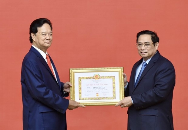 Former Prime Minister presented with 55-year Party membership badge