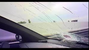 Large Rock Falls from Overpass, Shattering Car Window on Highway